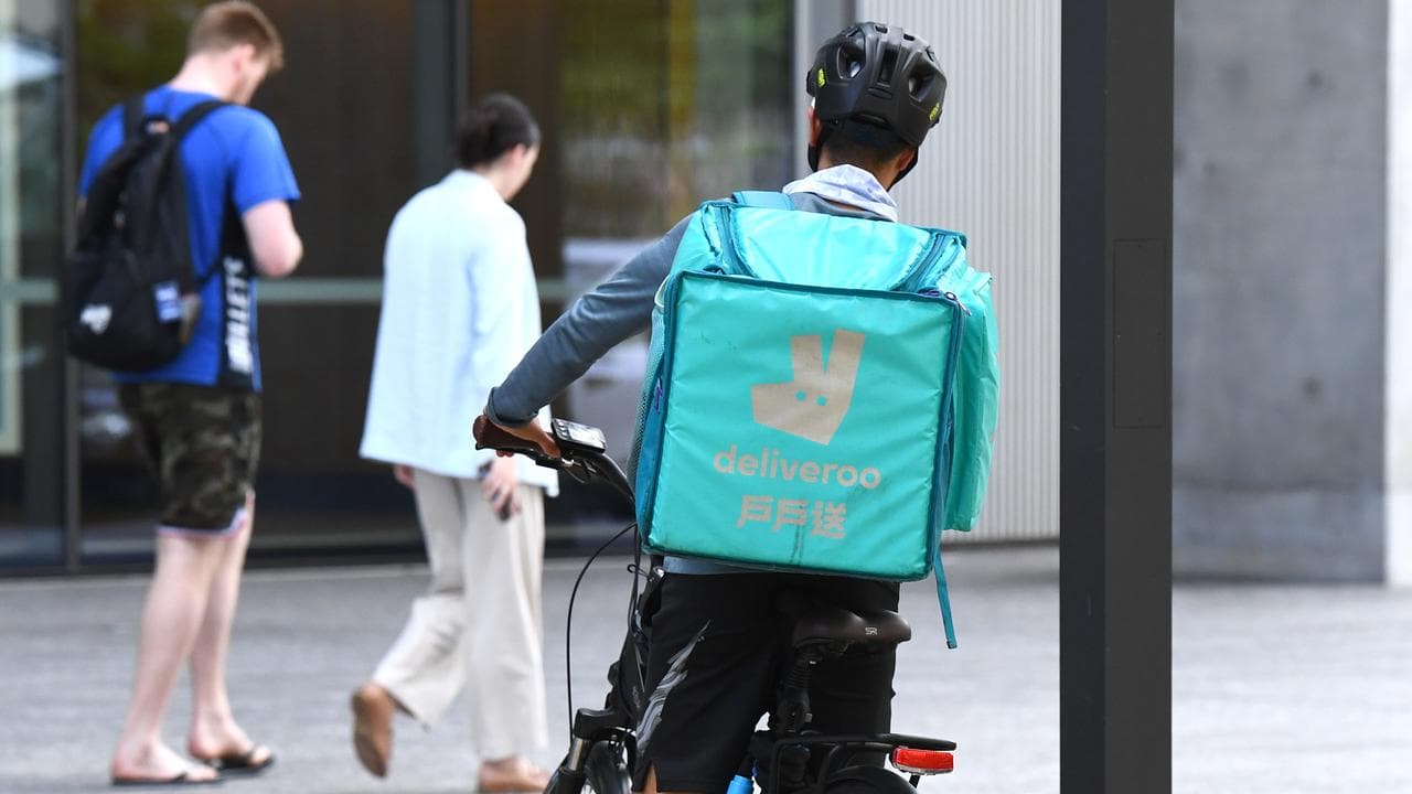 A Deliveroo worker outside a restaurant