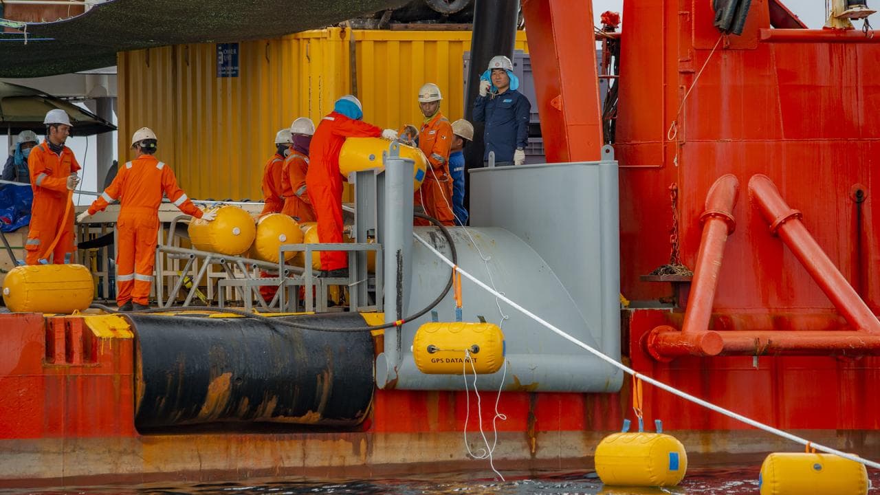 Machinery laying undersea cable.