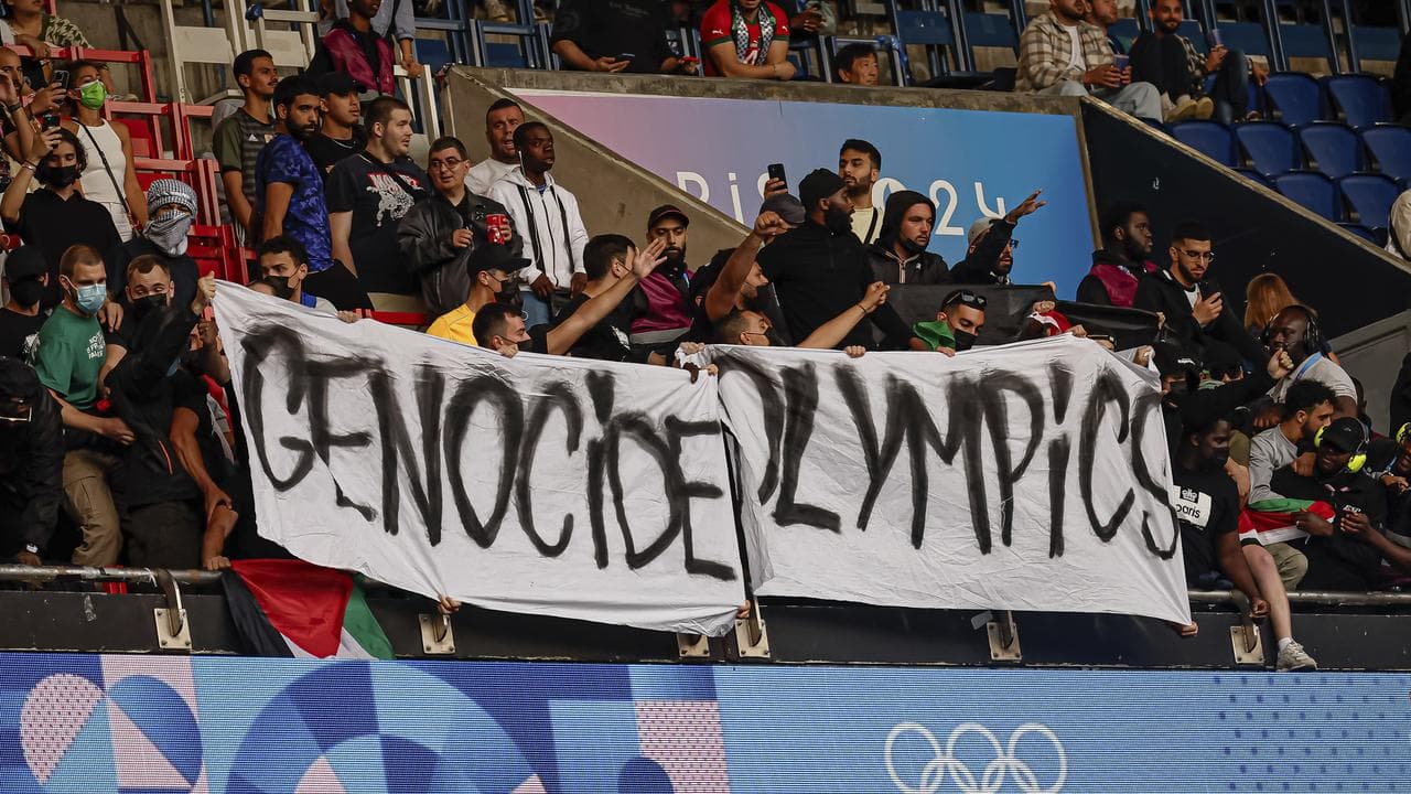 Protesters against Israel's inclusion hold a banner at a soccer match