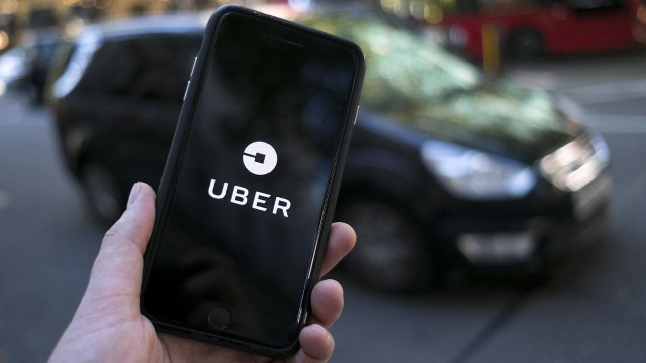 An Uber logo on a mobile phone