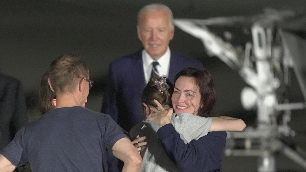 Alsu Kurmasheva hugs a family member at Andrews Air Force Base