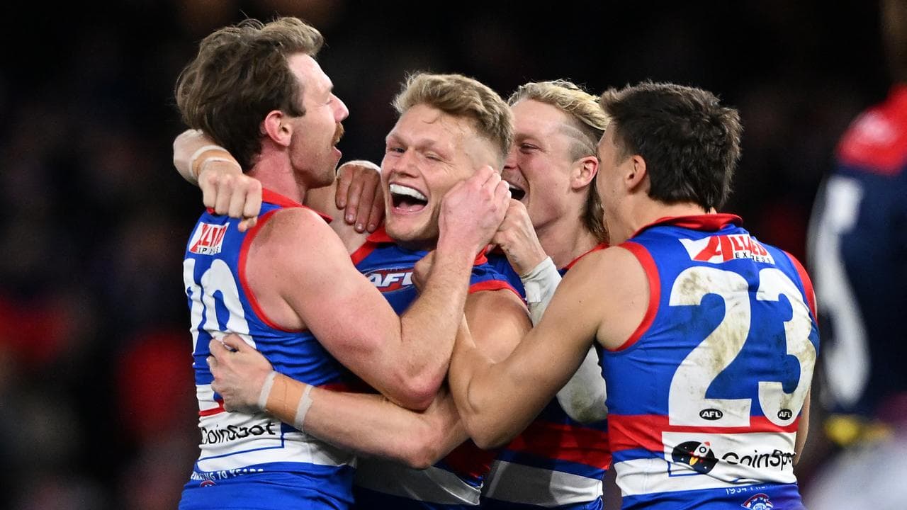 Bulldogs players celebrate a goal.