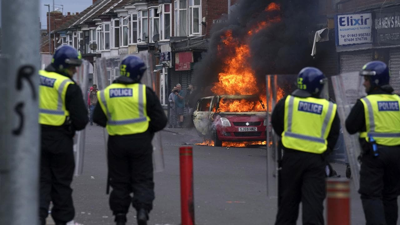 A car burns in an anti-immigration protest in Middlesbrough, England