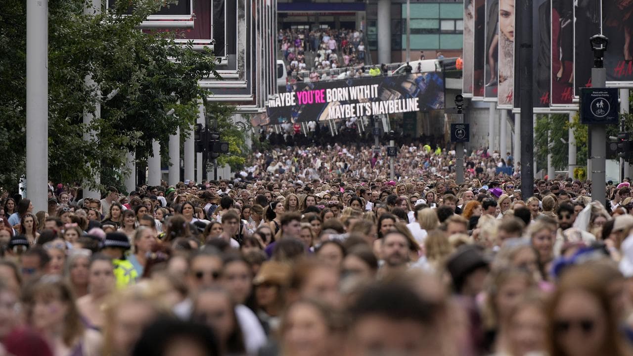 Fans of singer Taylor Swift arrive at Wembley Stadium in London
