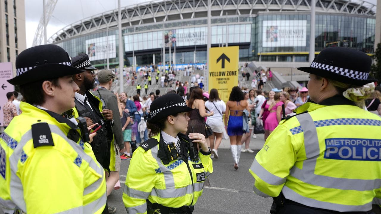 Police watch the arrival of Taylor Swift fans at Wembley Stadium