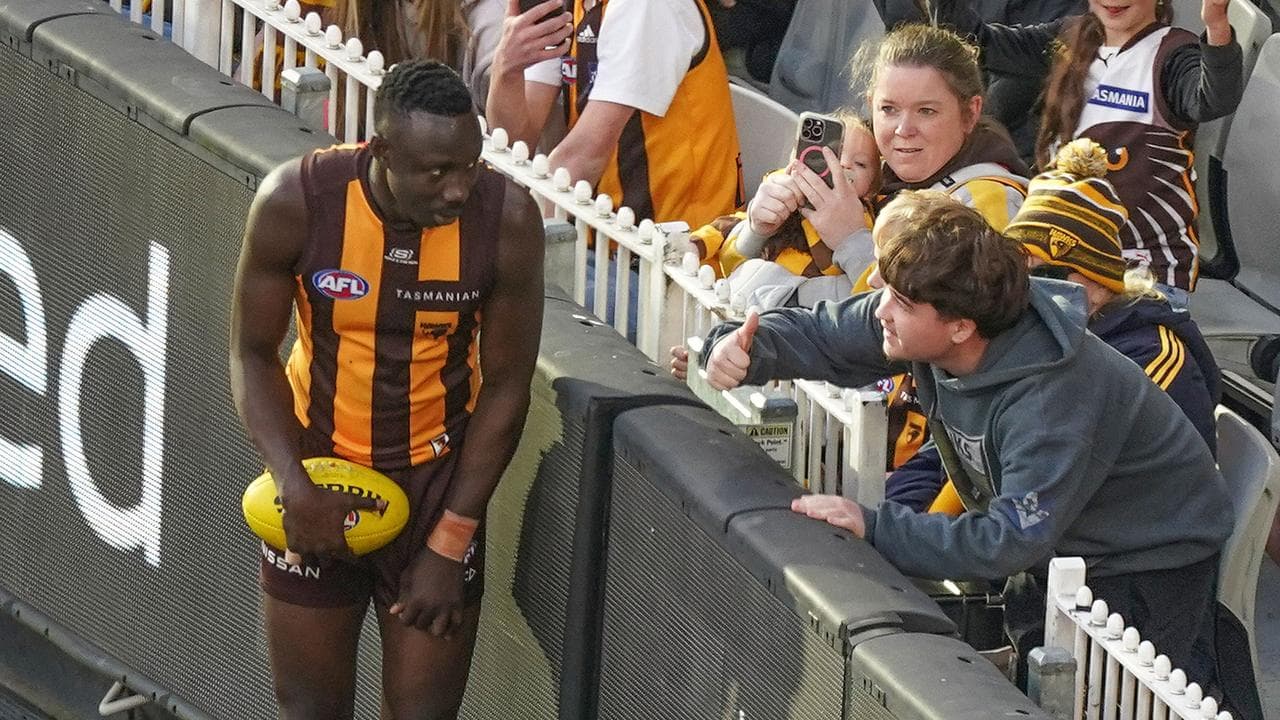 Mabior Chol interacts with a Hawks fan.