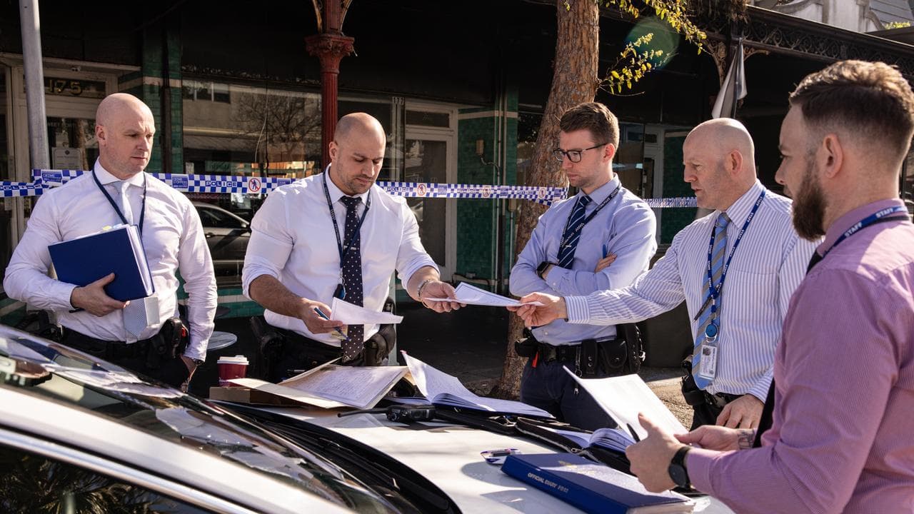 Investigators at the scene of a burnt hair salon in Port Melbourne