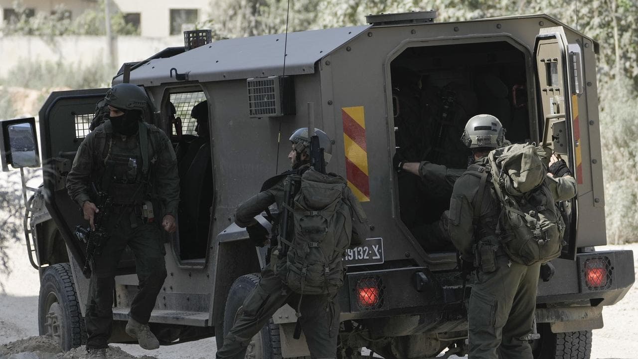 Israeli forces prepare to enter a West Bank refugee camp