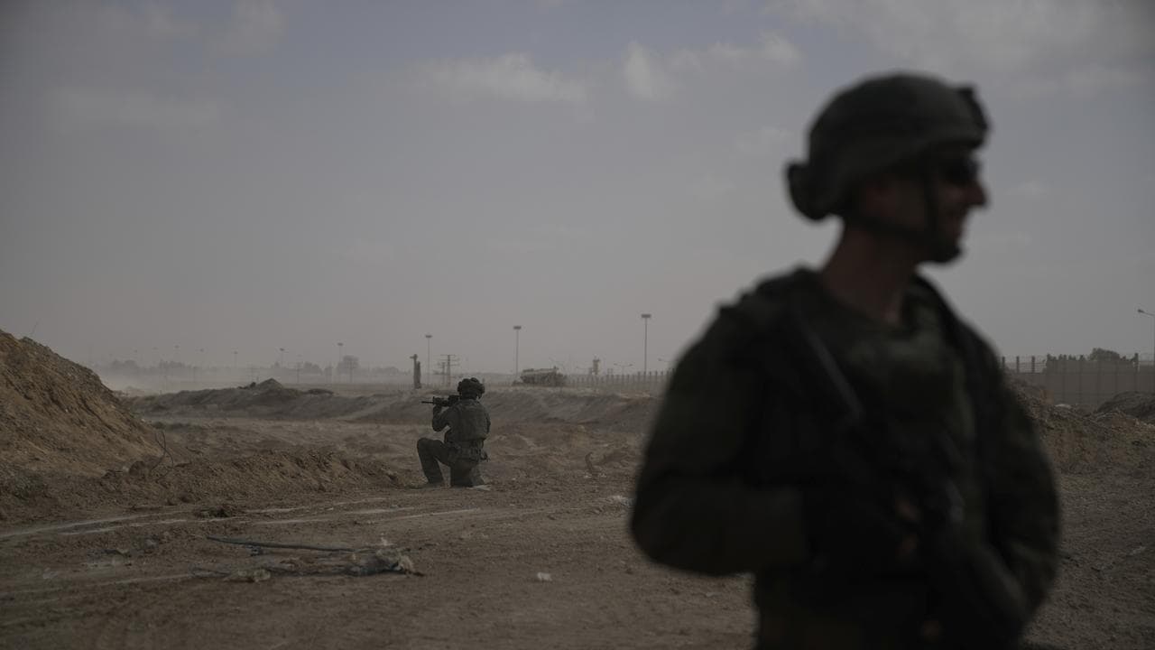 Israeli soldiers take up positions next to the Philadelphi corridor