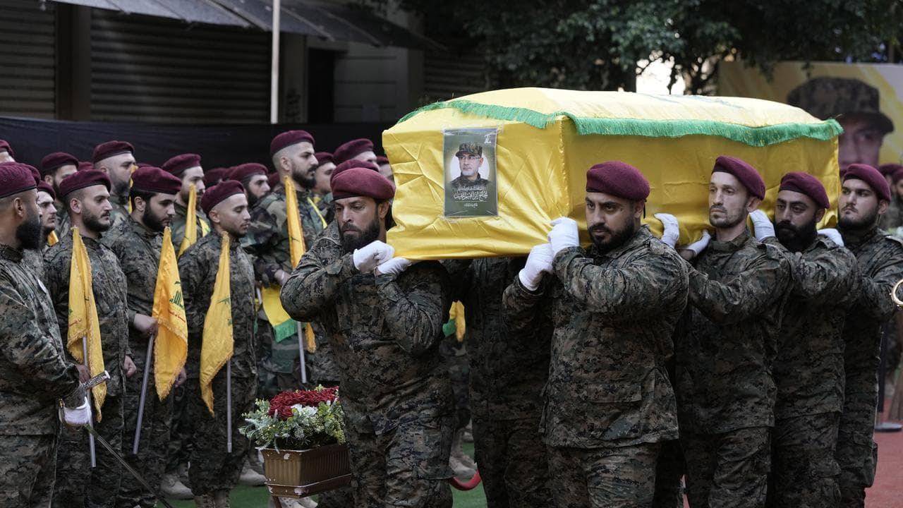 Hezbollah members carry the coffin of Hezbollah commander Ibrahim Akil
