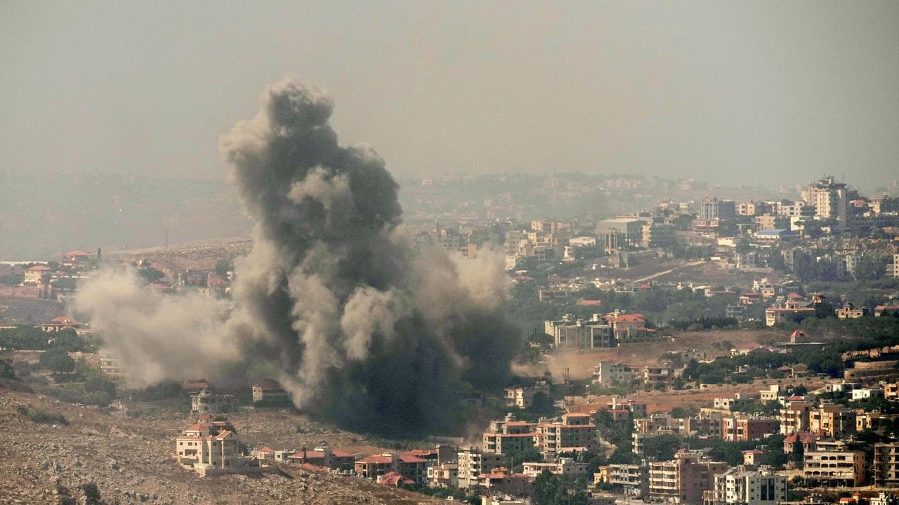 Smoke rises from an Israeli air strike in Kfar Rouman