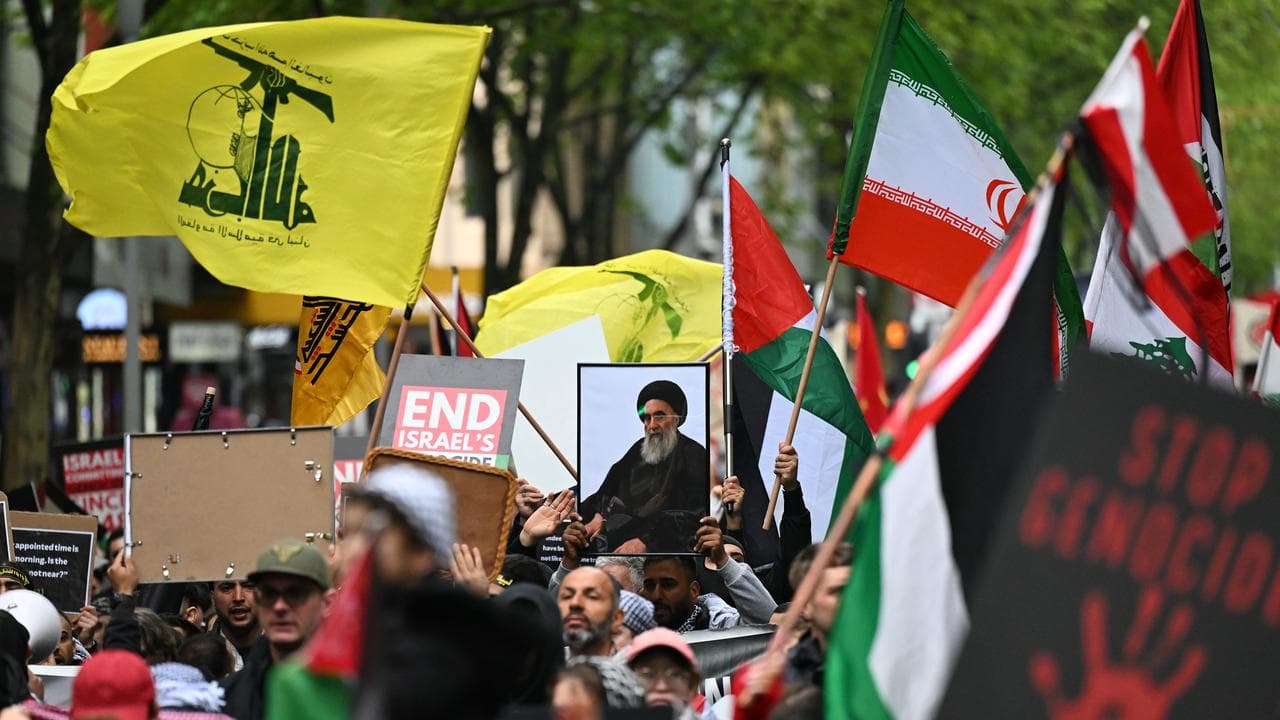 Hezbollah and Palestine flags at a rally