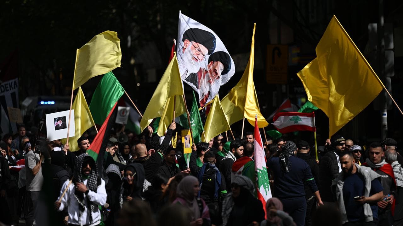 A group of Melbourne protesters waved flags coloured yellow and green.