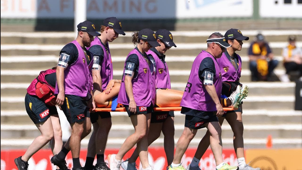 Mackenzie Eardley is carried off on a stretcher.