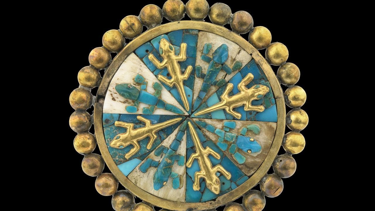 An ear ornament of gold, shell, and stone