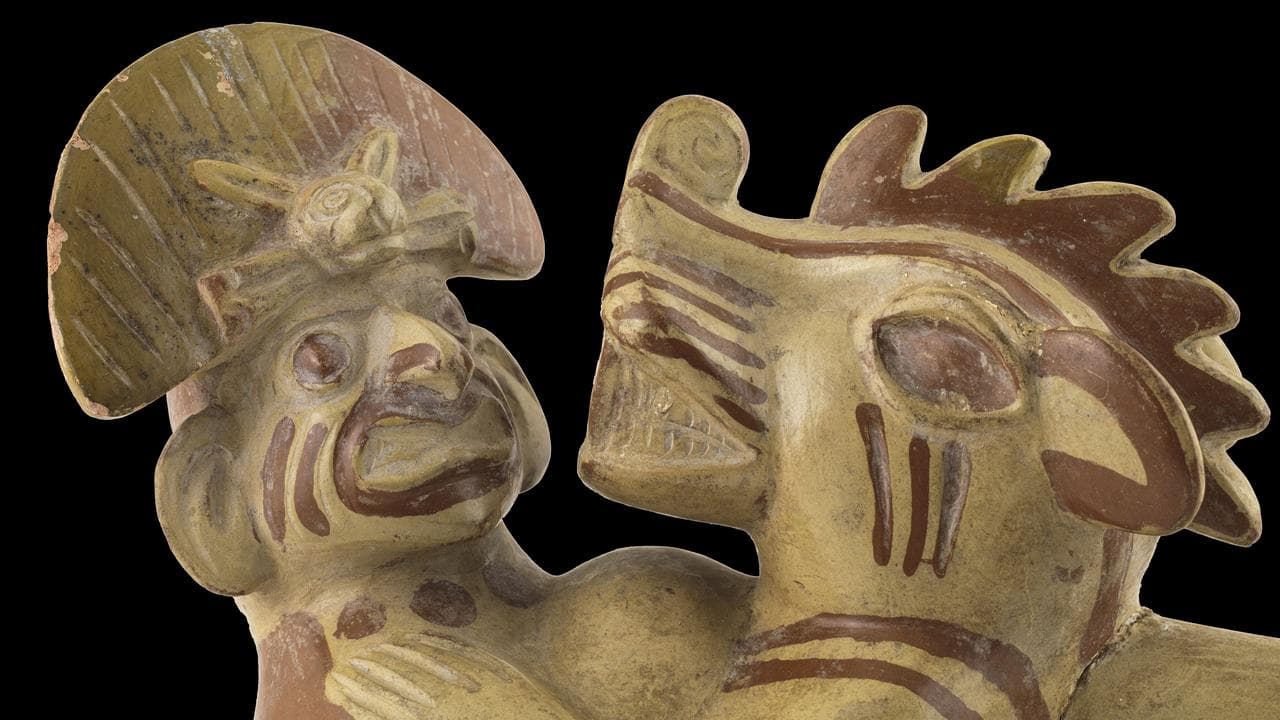 A sculptural stirrup spout bottle depicting an anthropomorphic figure