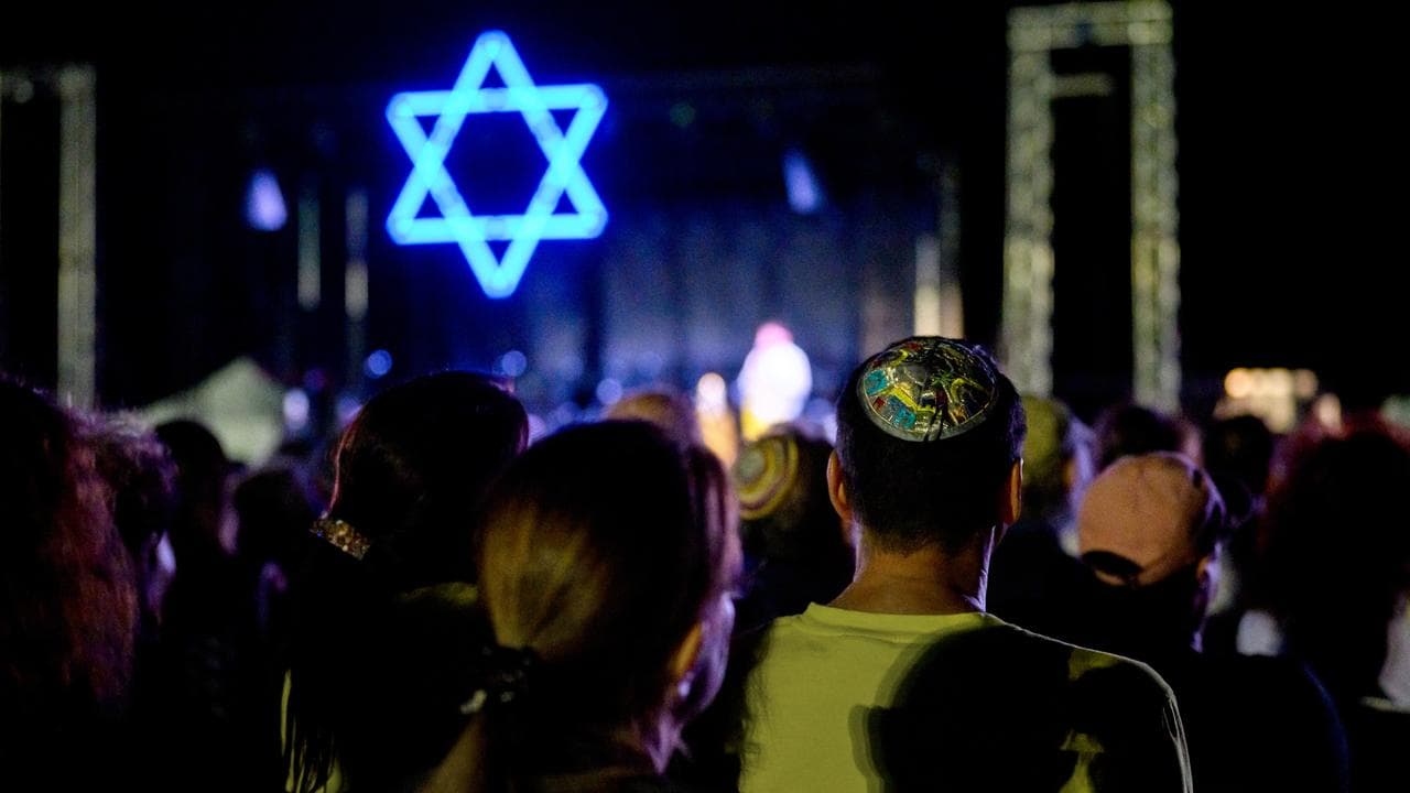 The crowd look on during a Jewish community vigil