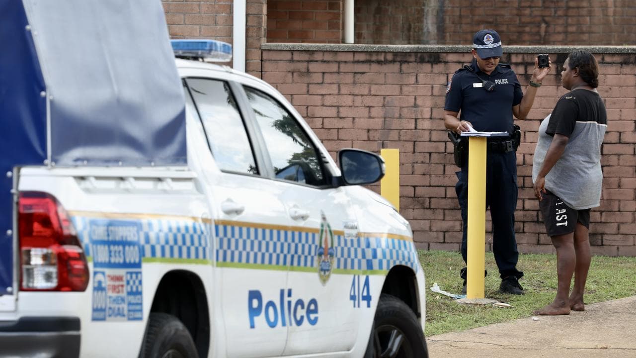 Police interview residents at the scene of a fatal stabbing in Malak