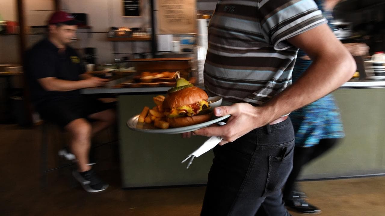 Employee serves a plate of food