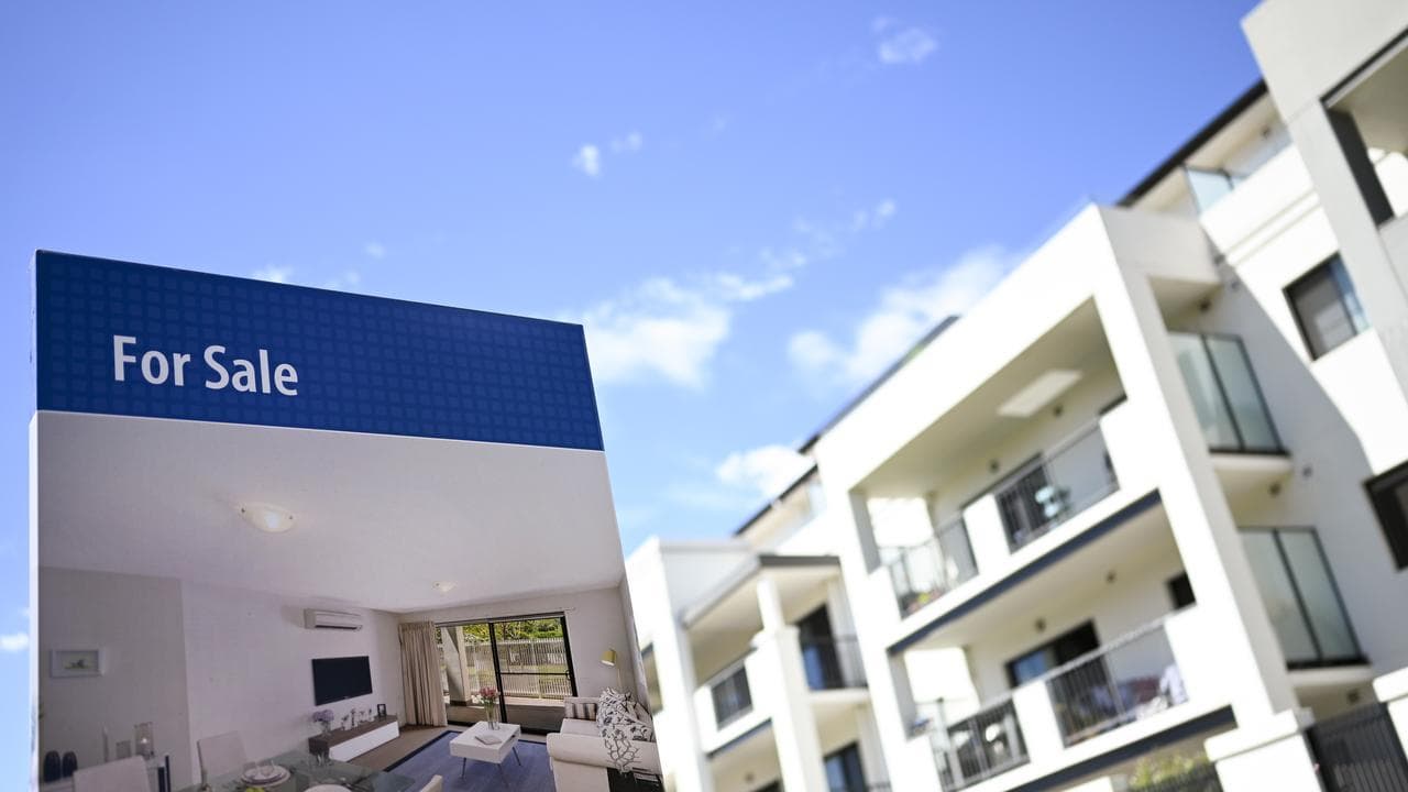 For Sale sign next to homes