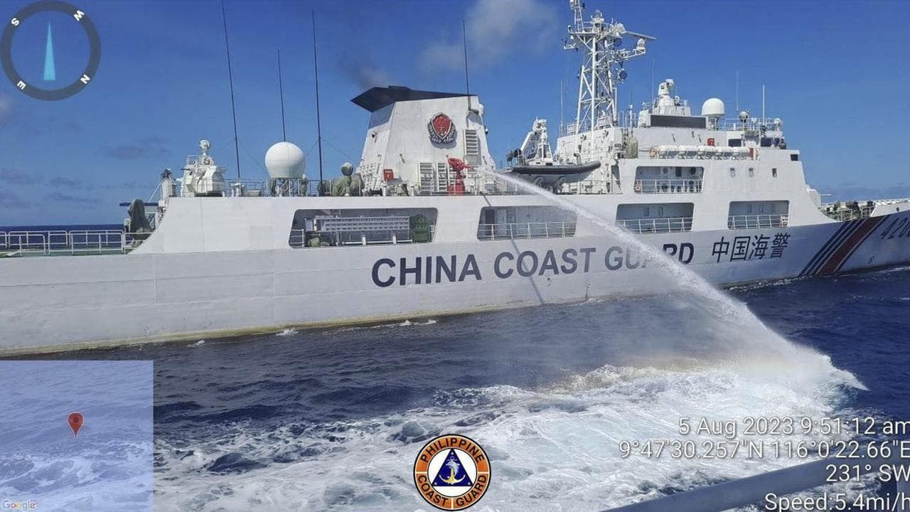 A Chinese coast guard ship uses water canons on a Philippine ship