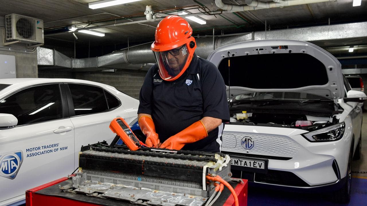 Trainer works on an electric vehicle battery