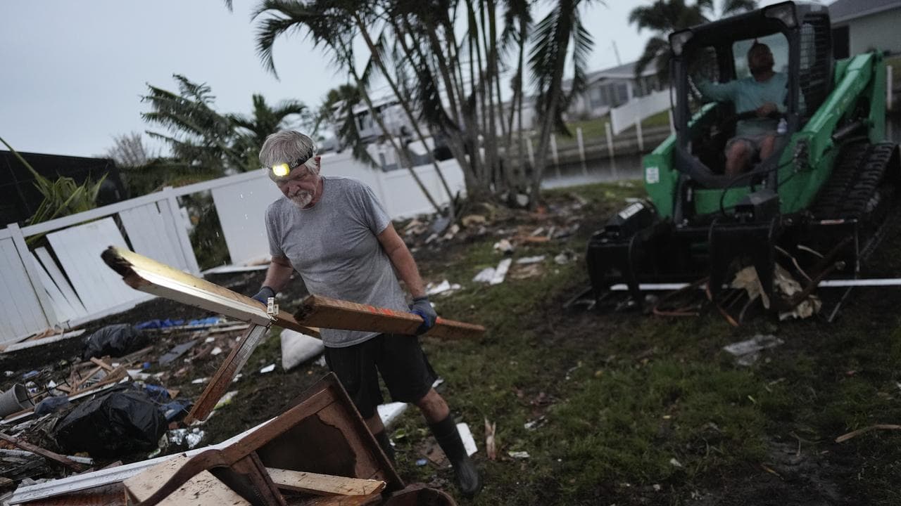 A man clearing hurricane debris