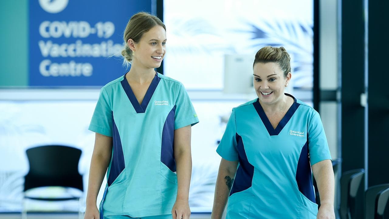 Zoe Park (l), after being vaccinated with nurse Kellie Kenway