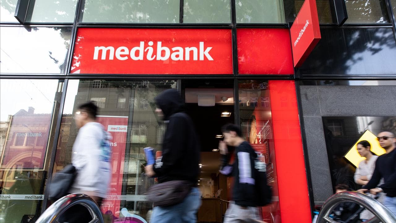 People walk past a Medibank store