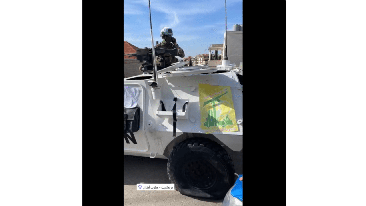 Close-up of punctured tyre on UNIFIL vehicle bearing Hezbollah flag.