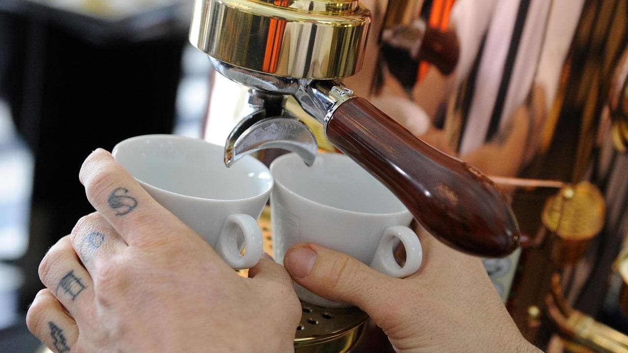 A barista makes coffee in the Birdcage at Flemington racecourse
