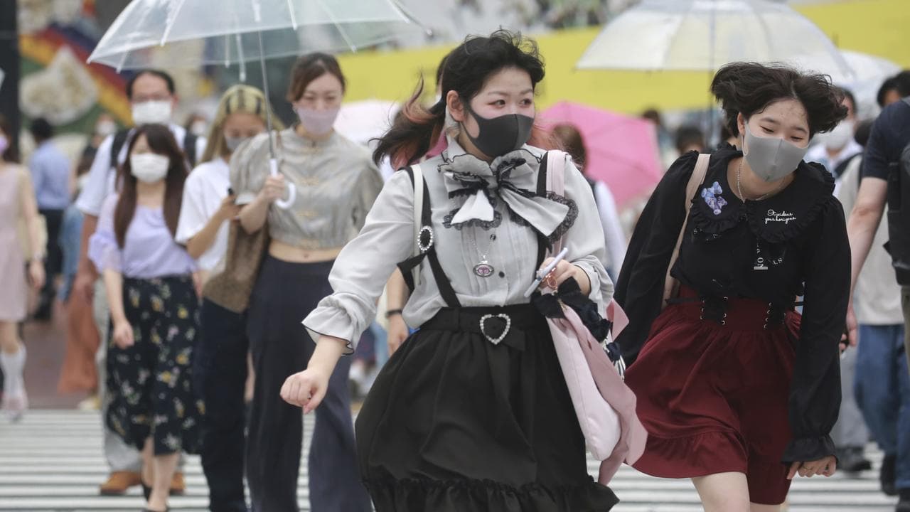 People wearing face masks in Japan in 2021 during the COVID outbreak.