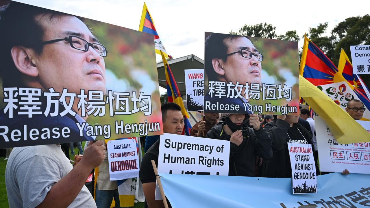 Yang Hengjun are seen during a rally