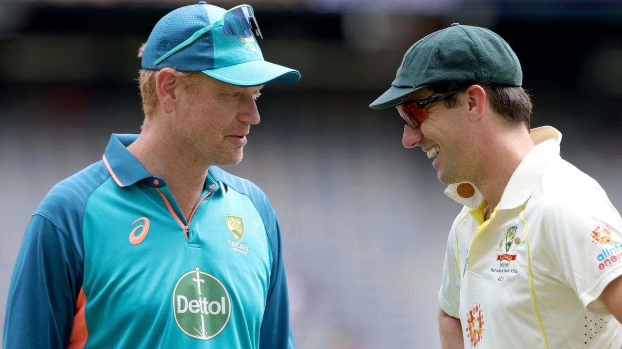 Australian coach Andrew McDonald (left) and Pat Cummins (right).