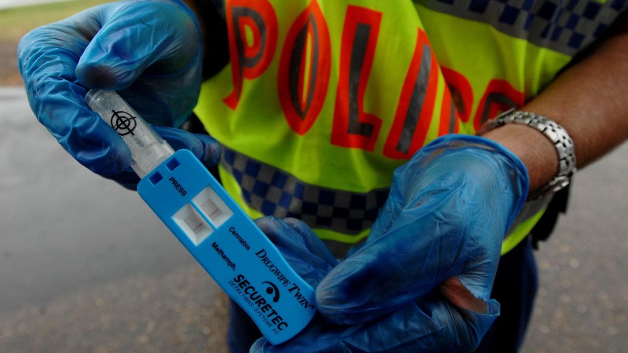 A police officer holds a drug tester