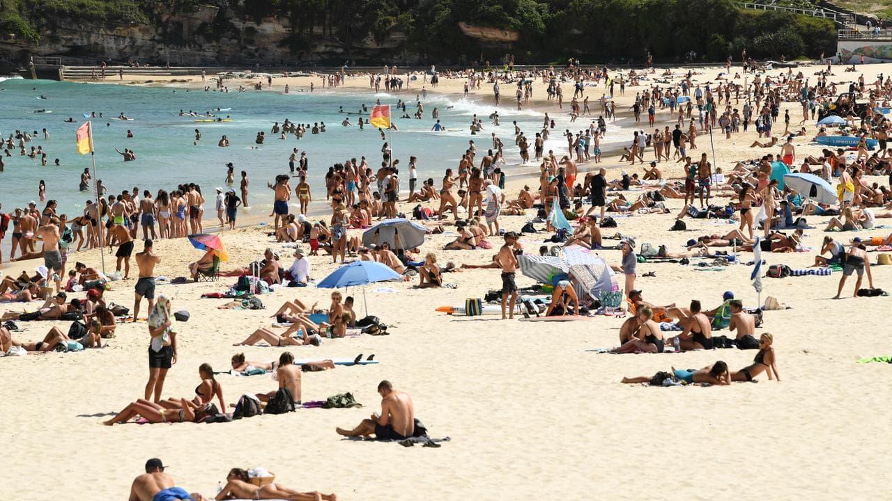 Beachgoers cool off in the water at Bondi Beach