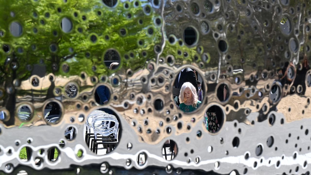 A person seen through the Ouroboros sculpture