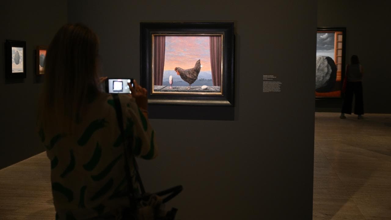 Patrons view artwork during a media preview of Magritte