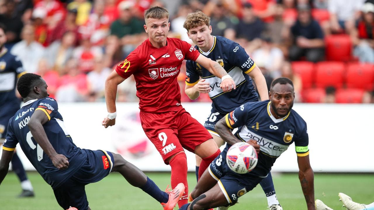 Adelaide United's Luka Jovanovic (centre).