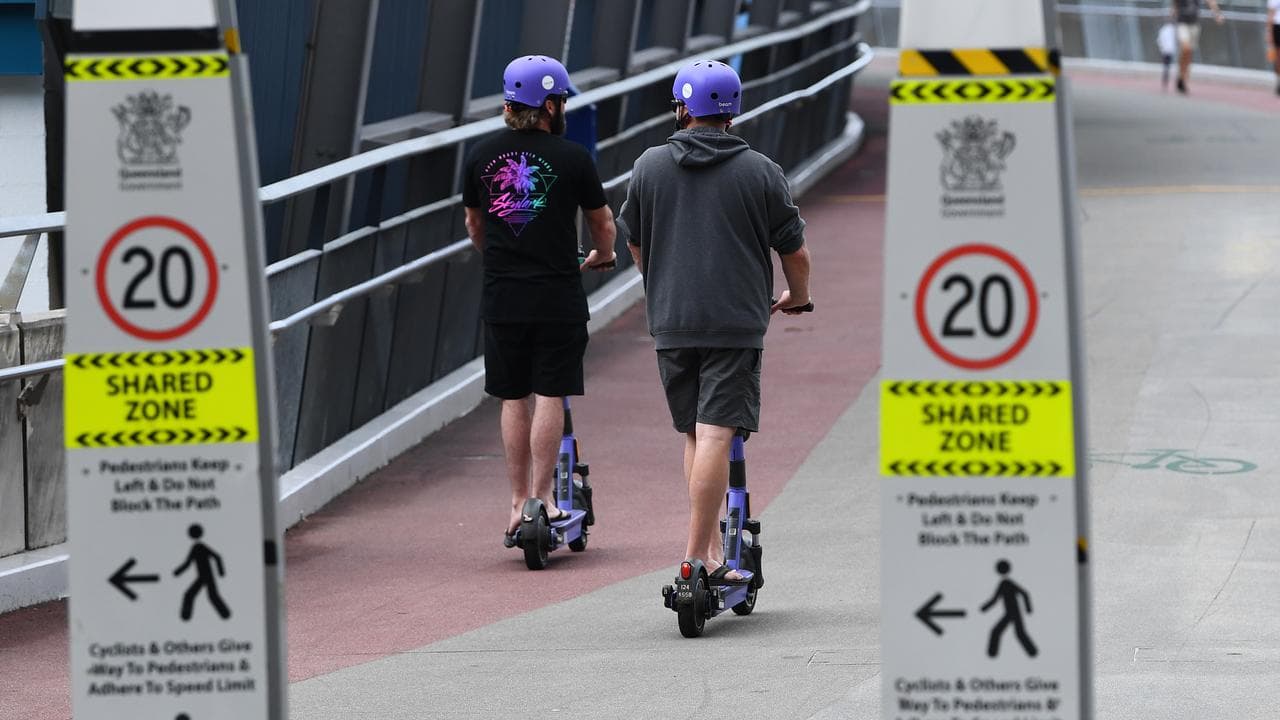 E-scooter riders near cycleway signs