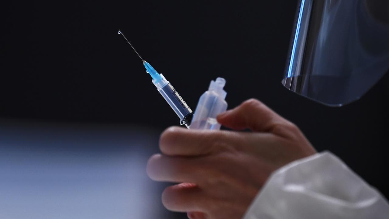 Healthcare worker prepares COVID-19 vaccination