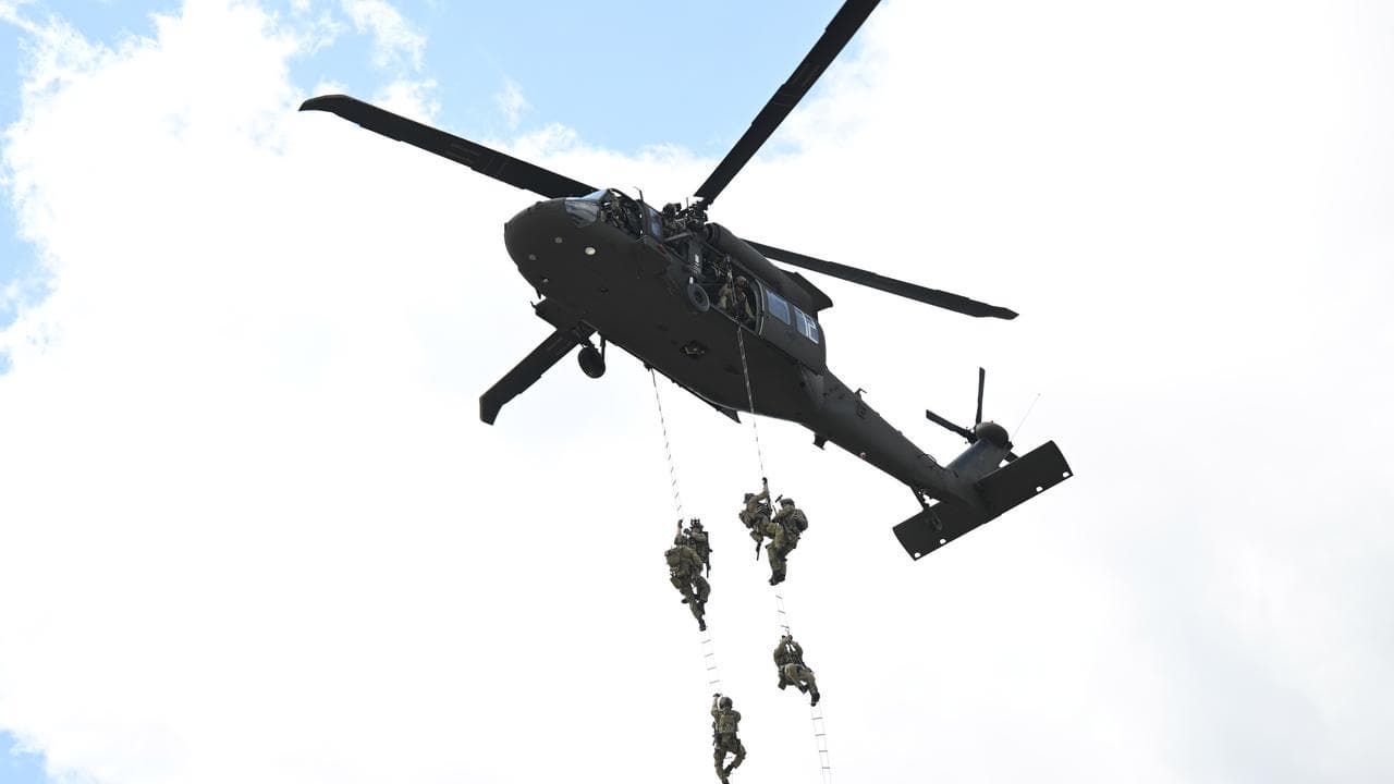 ADF troops are extracted to a Black Hawk helicopter in a mock exercise