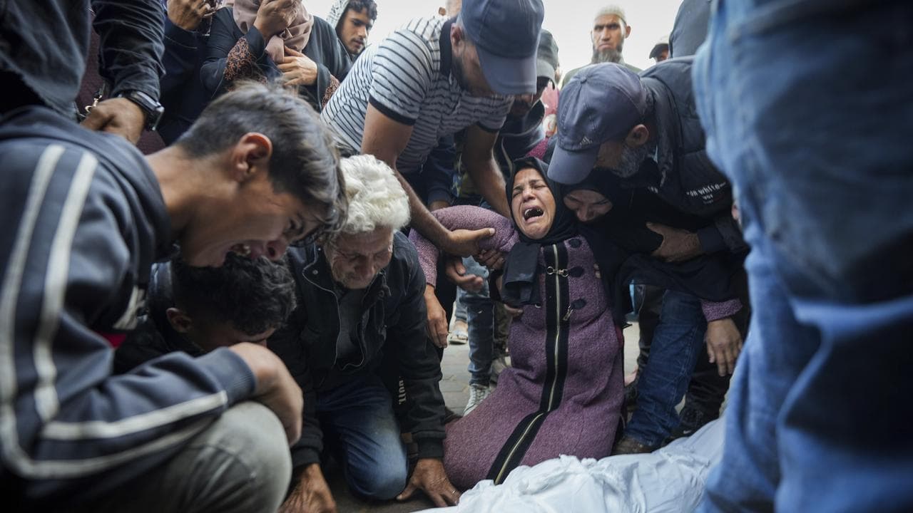 Palestinians mourn their relatives killed in the Israeli bombardment