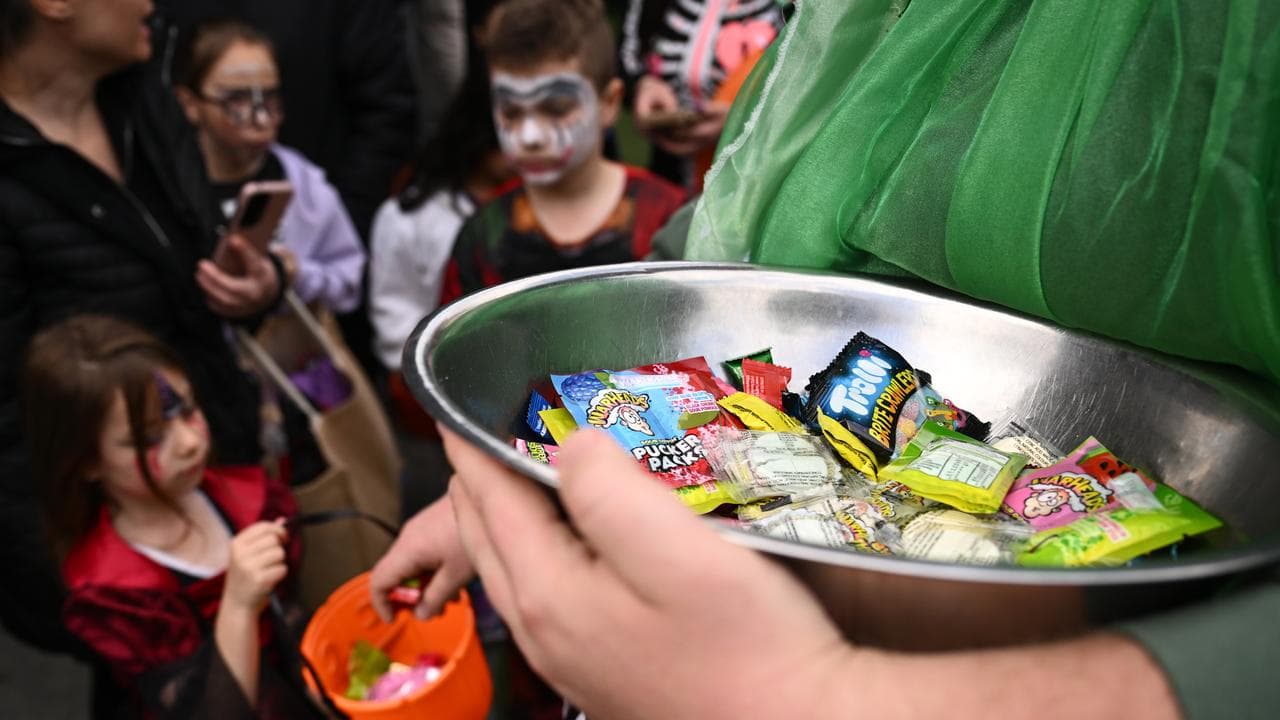 People wear costumes during Halloween