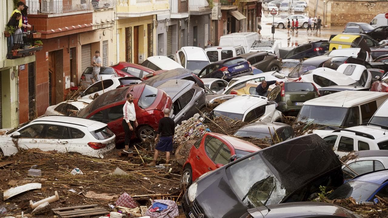 Residents after being swept away by floods in Valencia, Spain
