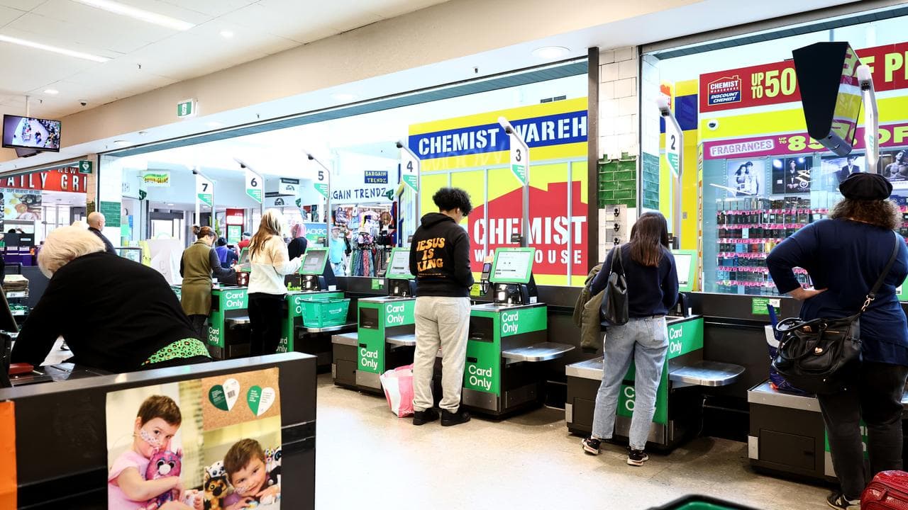 Shoppers at self-service check-outs.