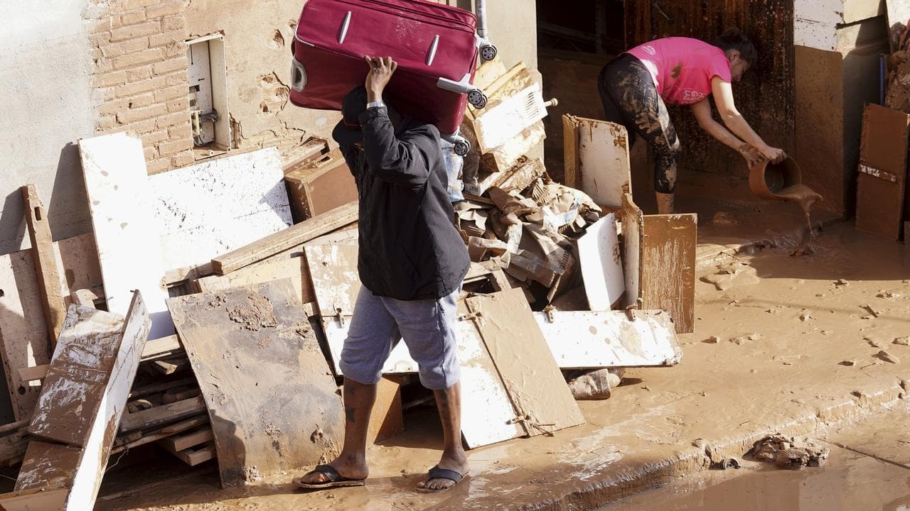 Residents clean their house affected by floods in Valencia, Spain