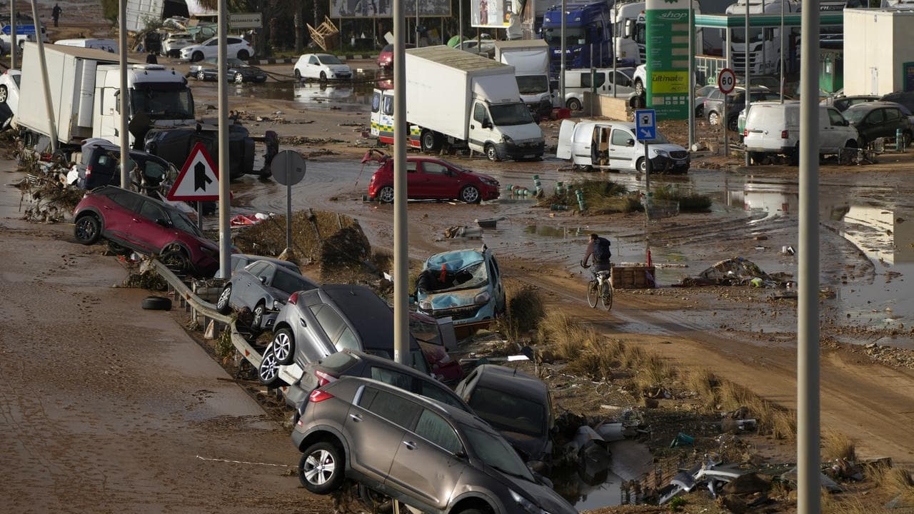 Vehicles piled up after being swept away by floods in Valencia, Spain