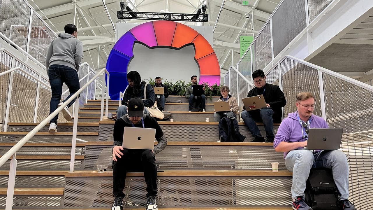 Coders on the expo floor at GitHub Universe 2024