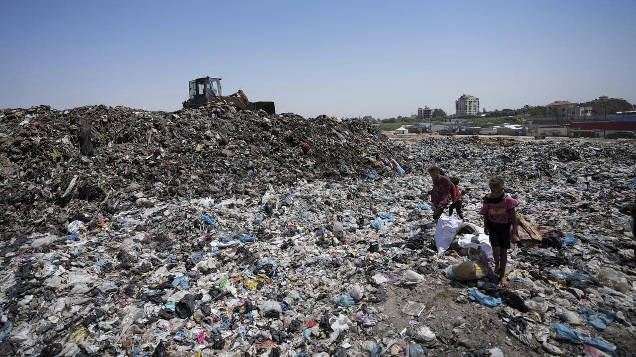 Children sort through rubbish in Gaza